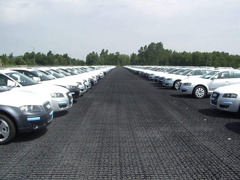 Driveway and Car Park Grid System – Heavy Duty Plastic Ground Reinforcement Cars parked on heavy duty black plastic driveway grids used for car park ground reinforcement