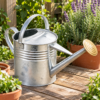 9L galvanised metal watering can in garden setting